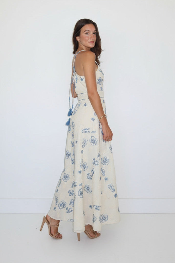 Woman wearing a floral dress against a white background