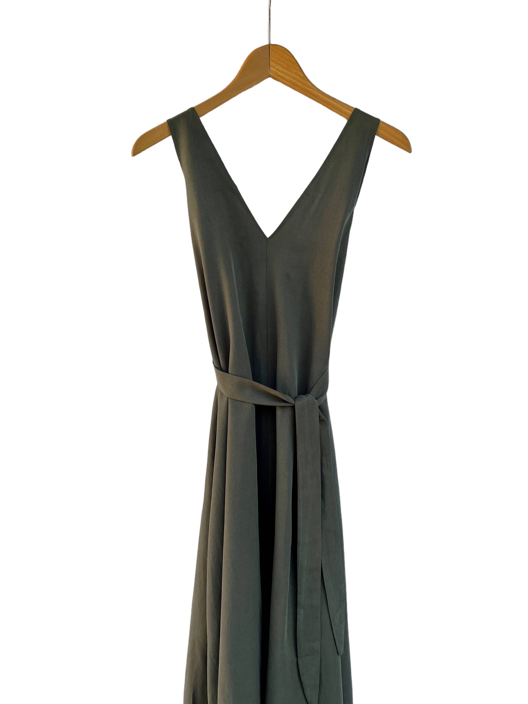 Green dress on a hanger against a white background