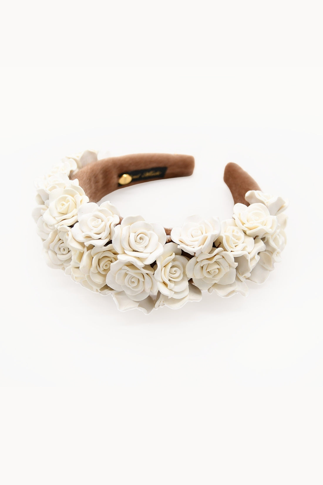 Floral headband with dusty rose accents on a white background