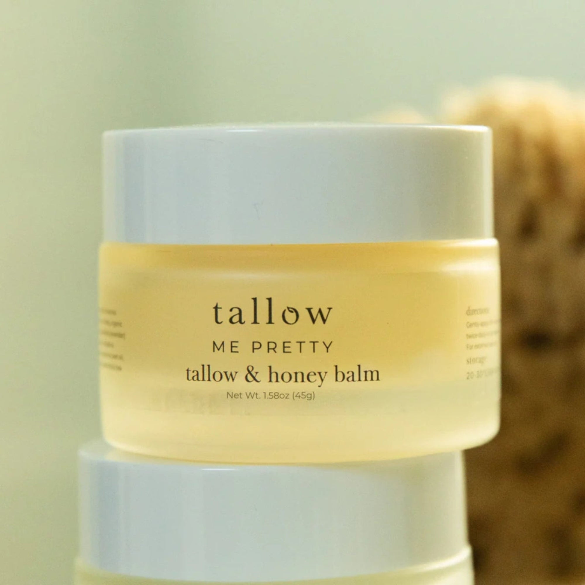 Tallow & Honey balm jar with 'tallow ME PRETTY' branding on a light green background