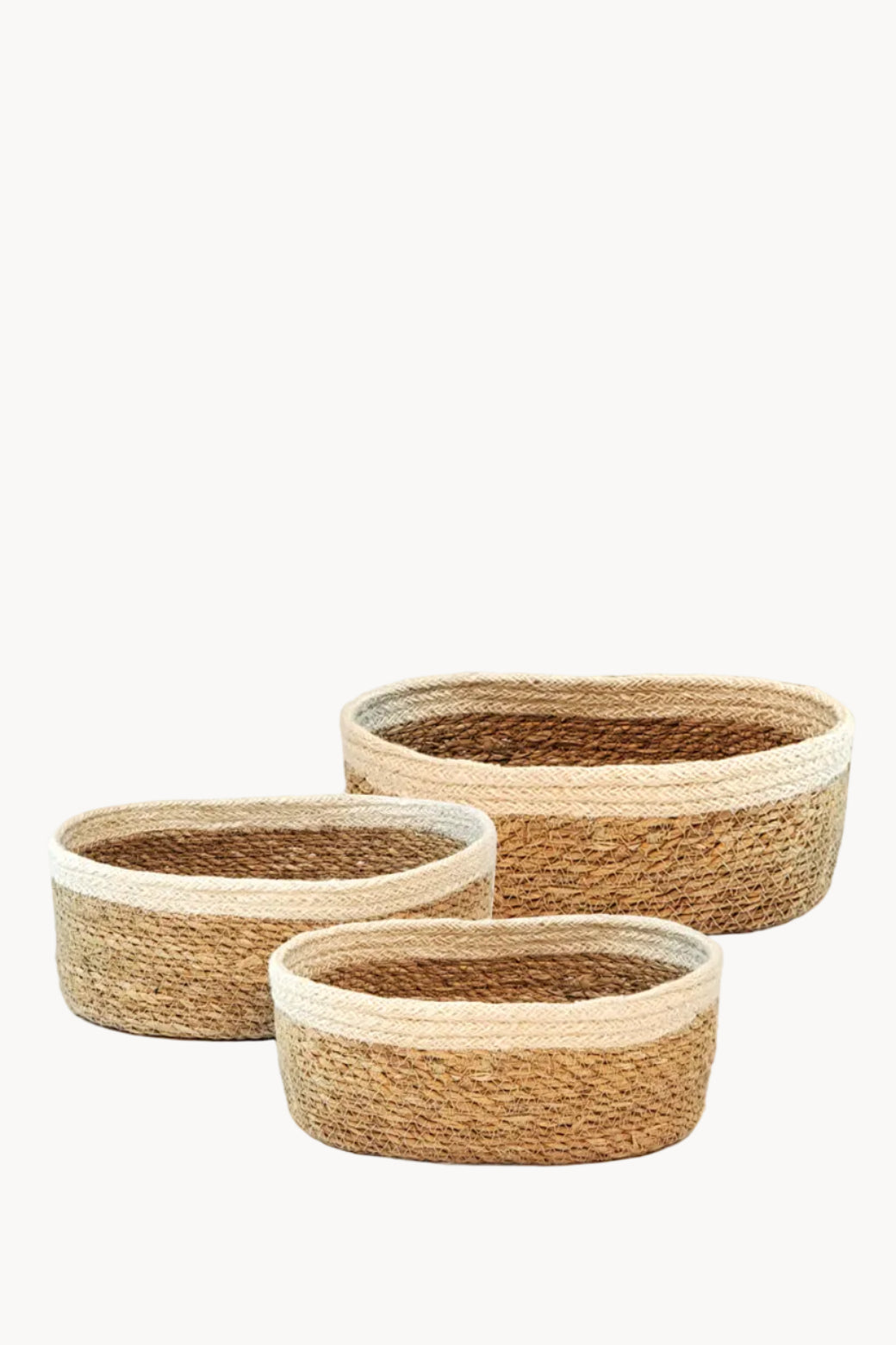 Three woven baskets of different sizes on a white background