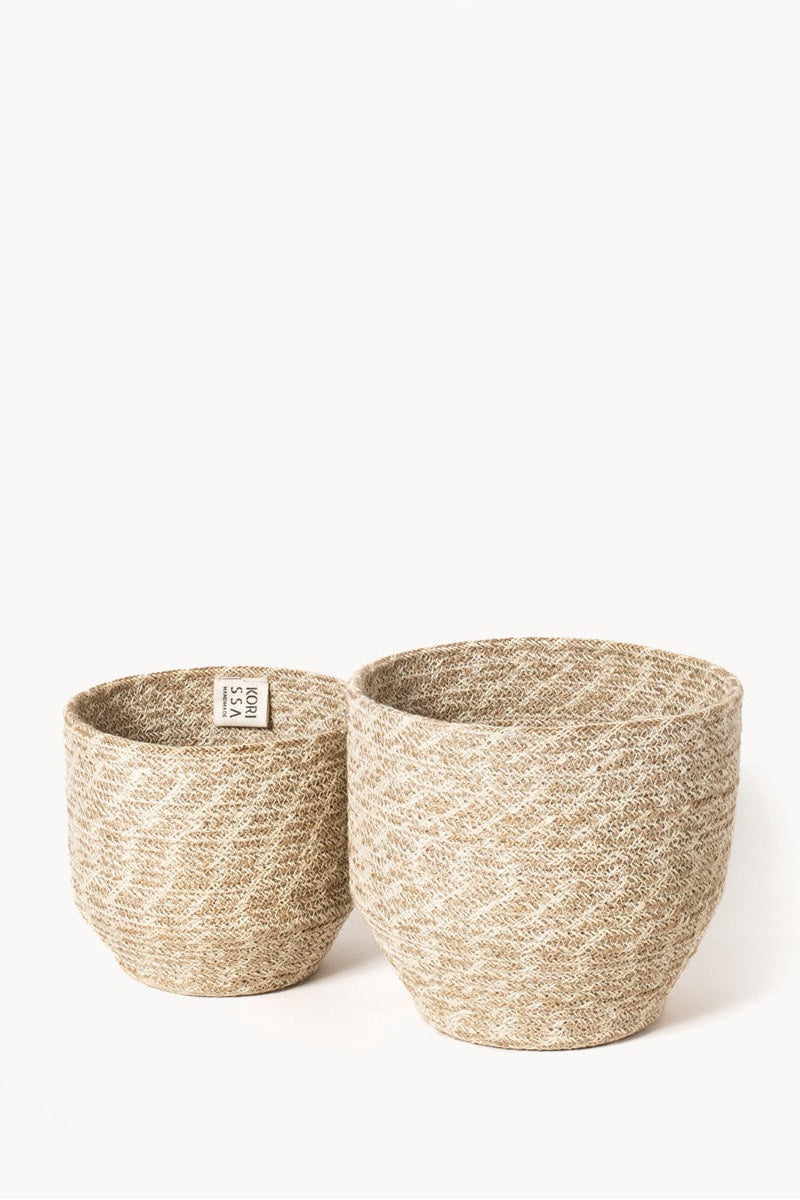 Two woven baskets on a white background