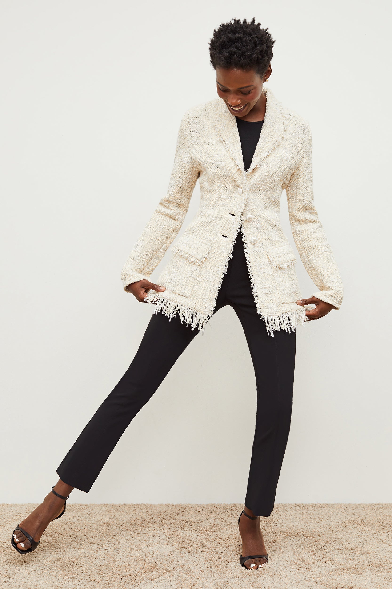 Front image of a woman standing wearing the porter jacket in taupe and ivory | Exclude