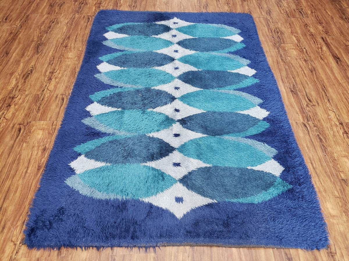 Blue geometric patterned rug on a wooden floor