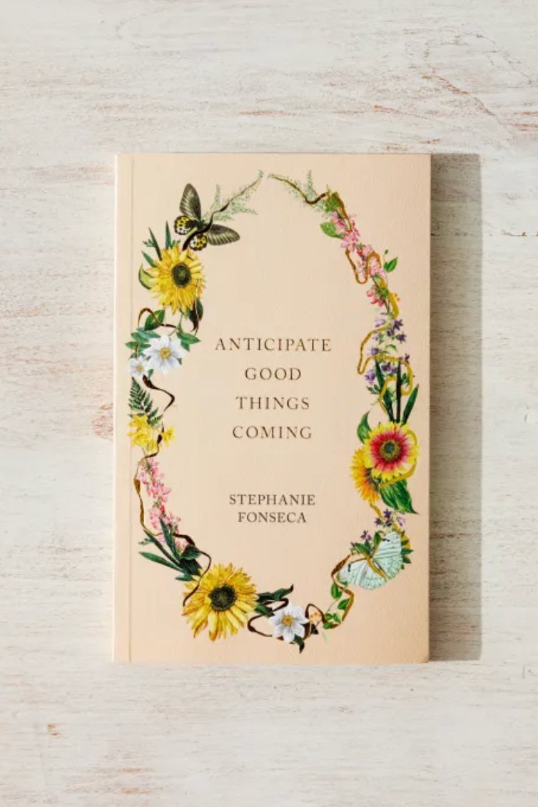 Book with floral design and text on a wooden surface