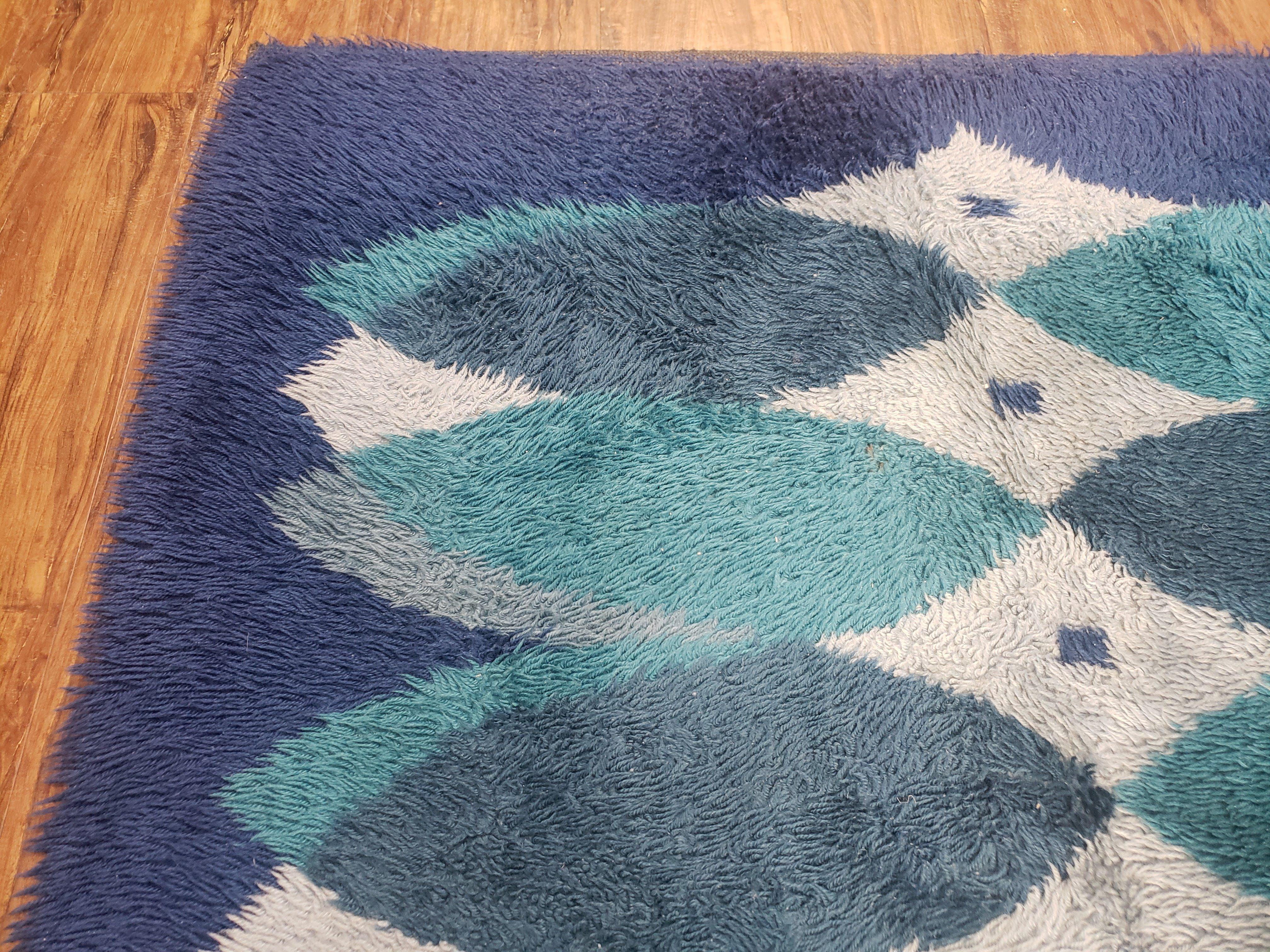 Blue and white geometric patterned rug on a wooden floor