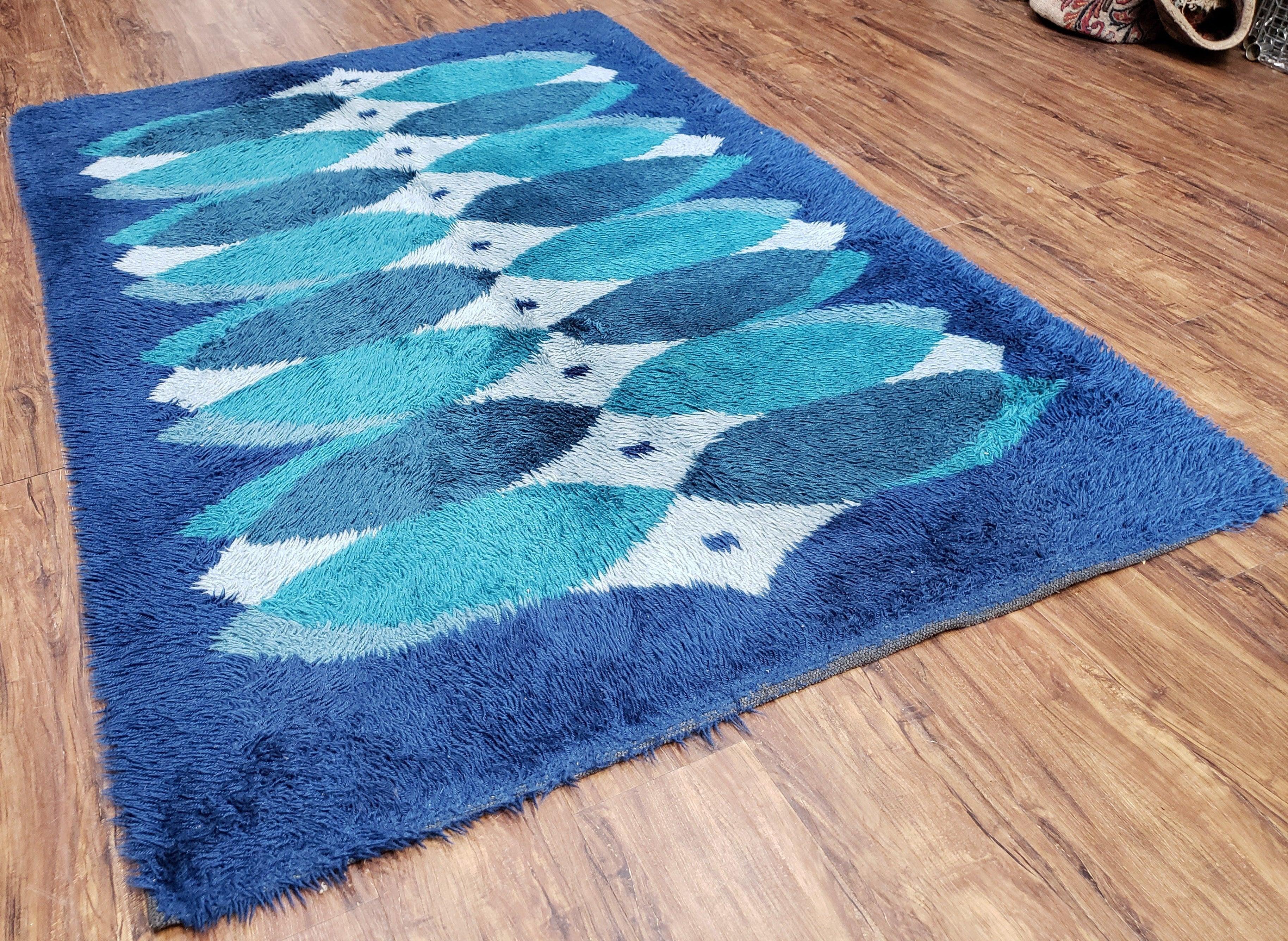 Blue patterned rug on a wooden floor