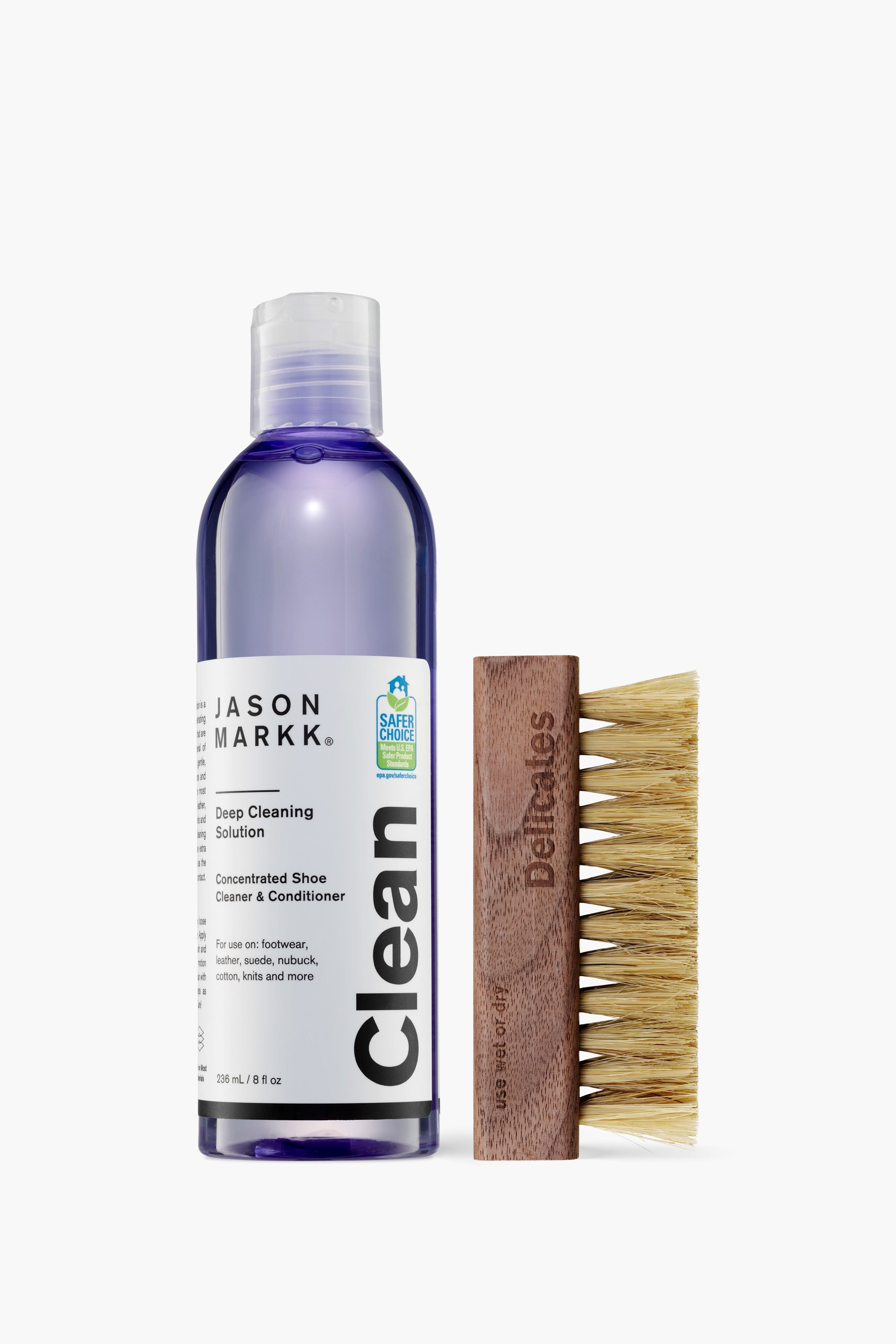 Jason Markk shoe cleaning solution bottle and brush on a white background