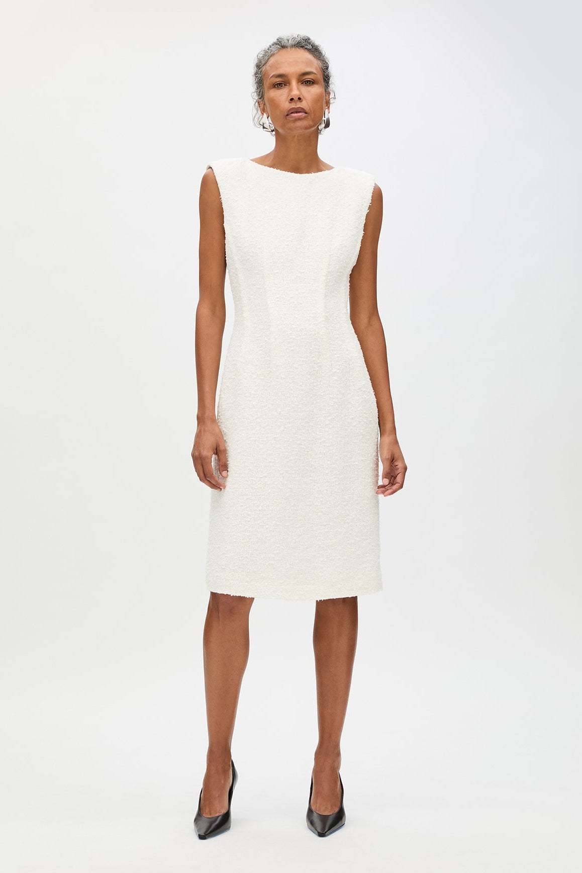 Woman wearing a white dress on a white background