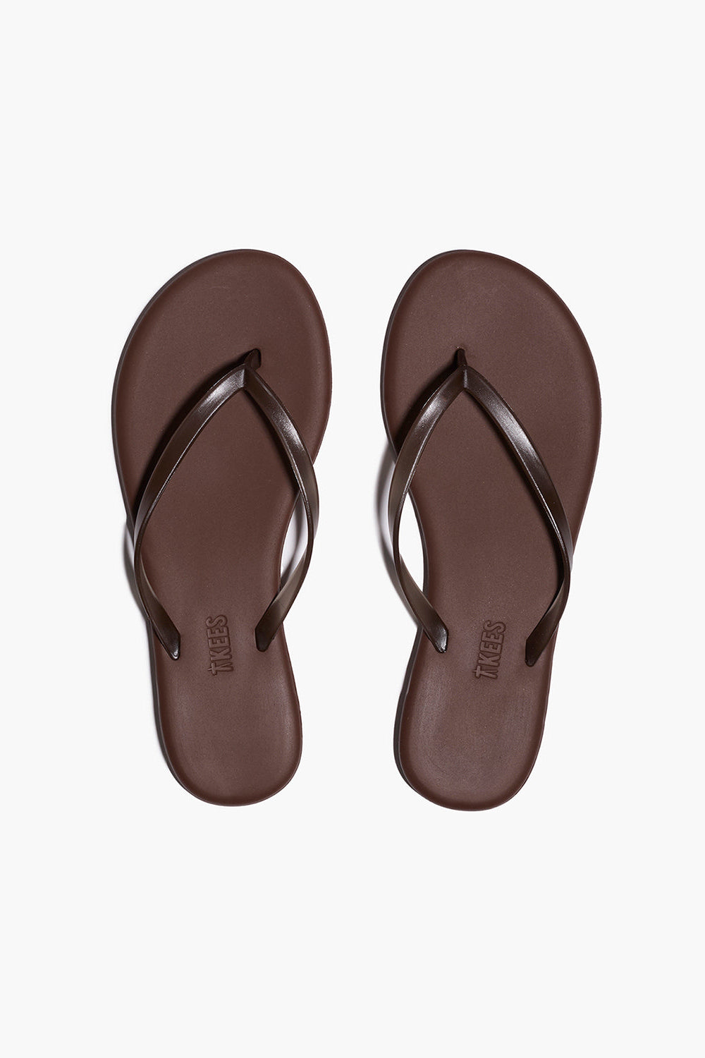 Pair of brown flip-flops on a white background