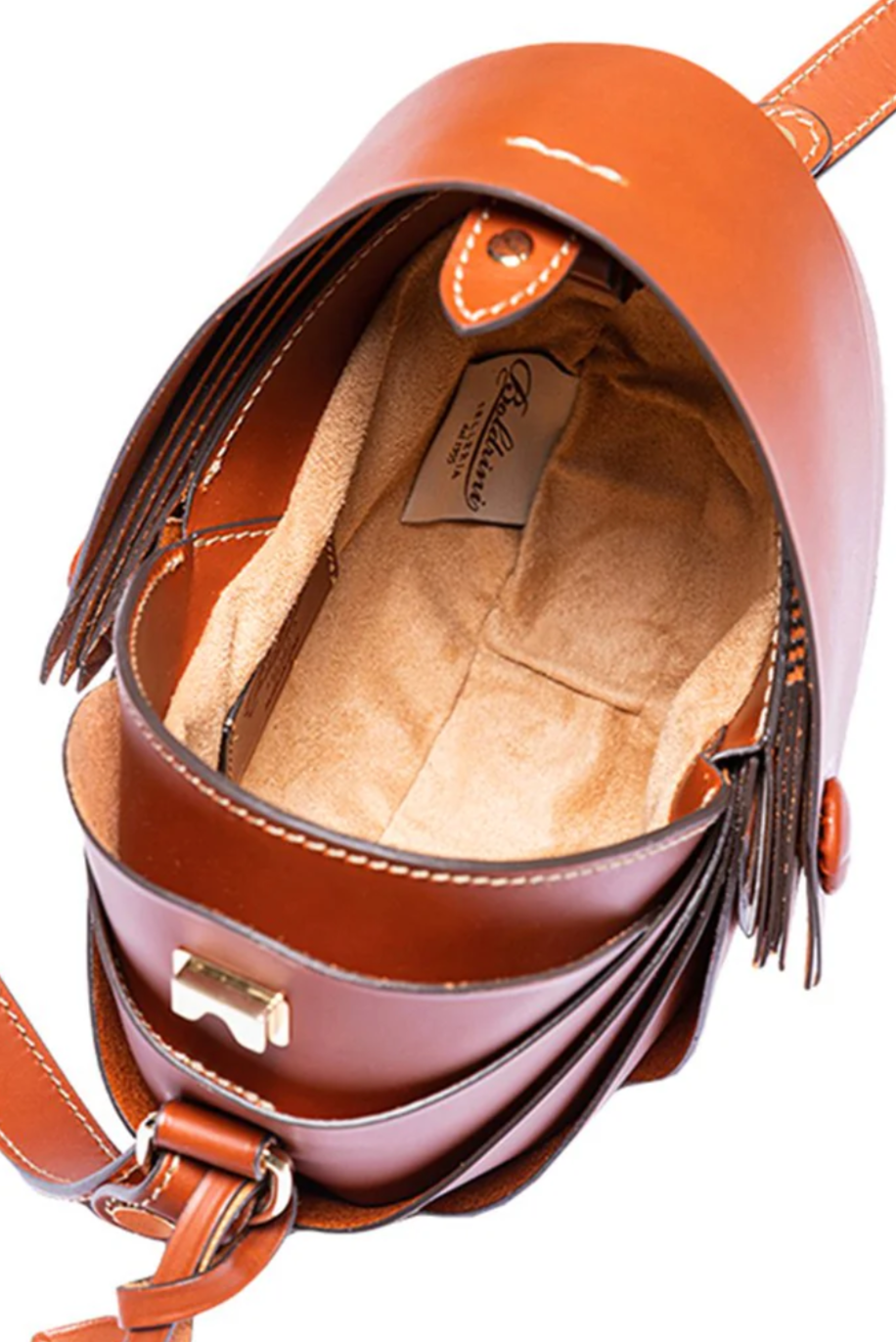 Brown leather handbag with fringe details on a white background