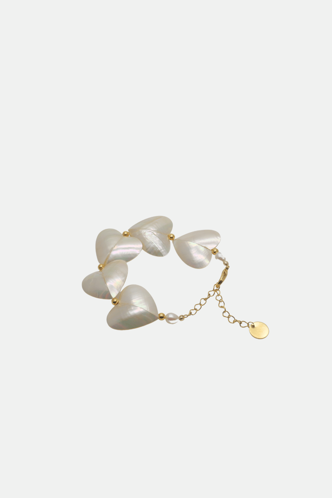 Pearl bracelet with gold chain on a white background