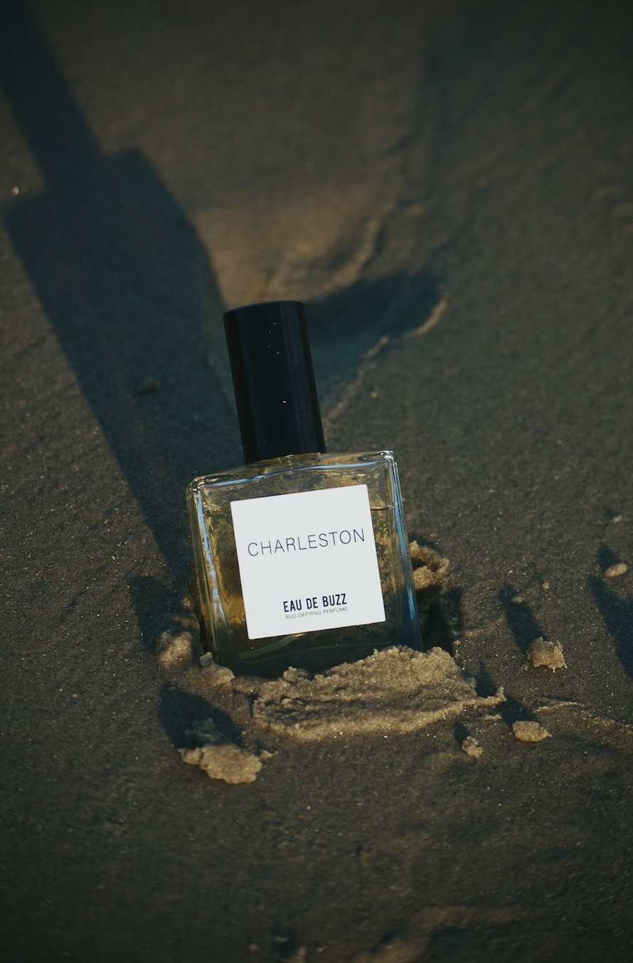 Perfume bottle labeled 'Charleston' on a textured surface