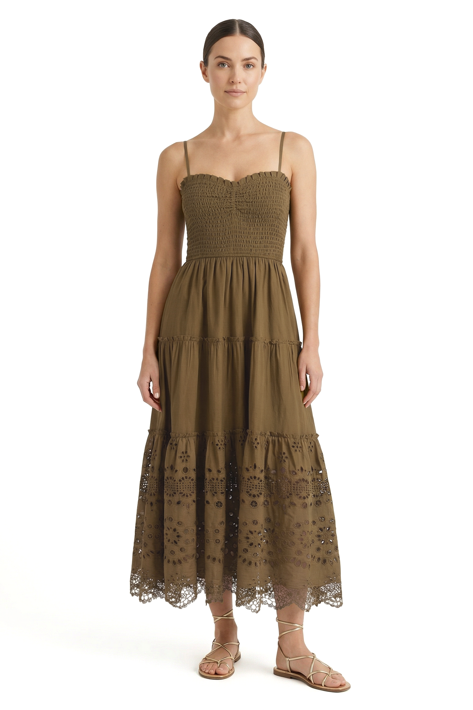Woman wearing a green dress with lace details on a white background