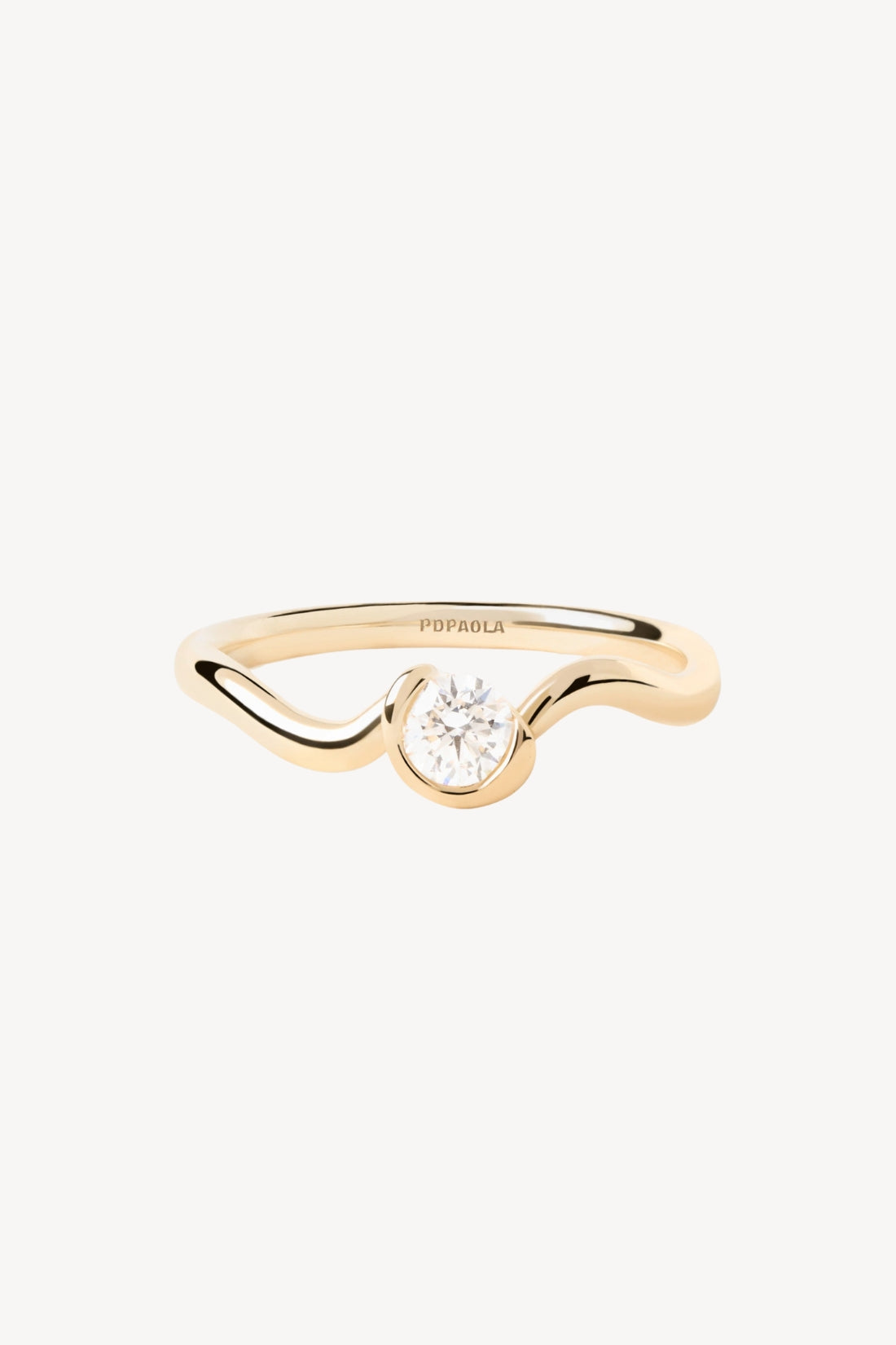 Wavy gold ring with a diamond on a white background