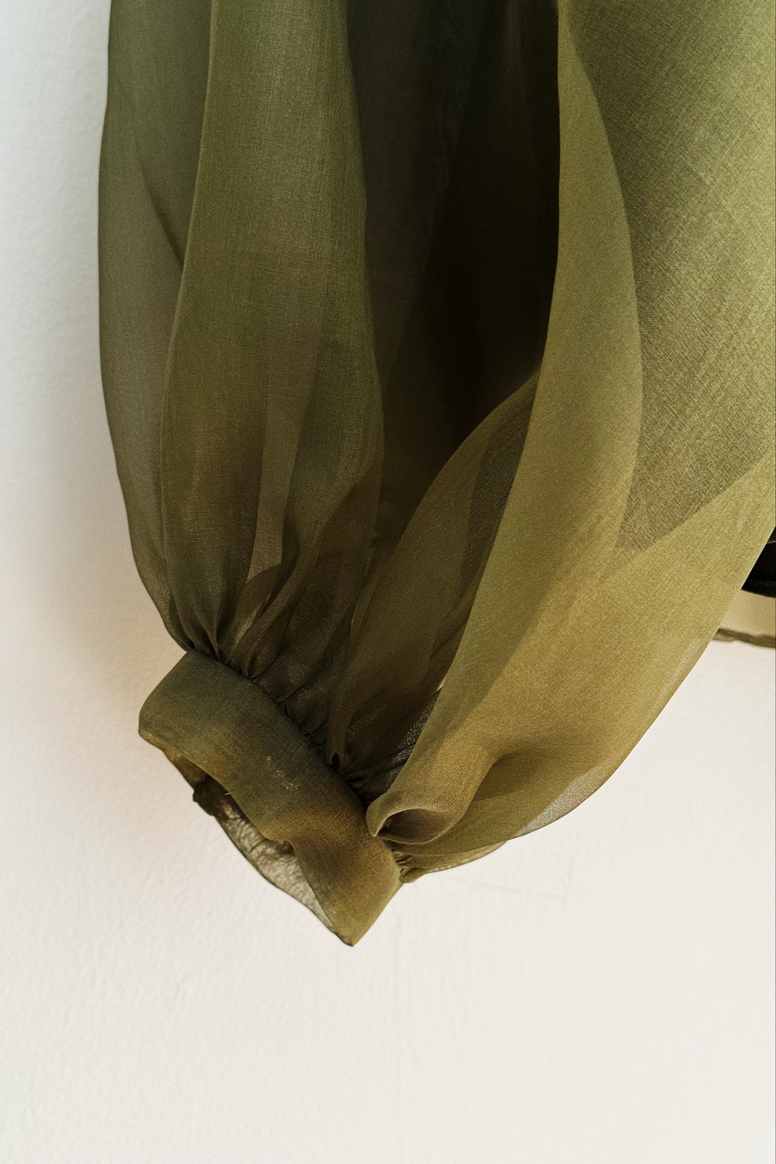 Green sheer fabric on a white background