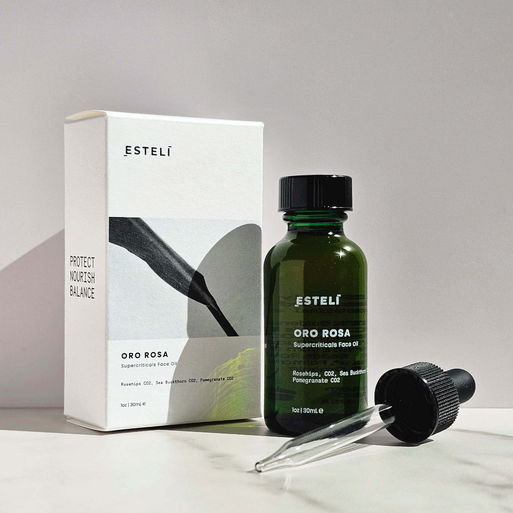 Esteló bottle with dropper and packaging on a light gray background