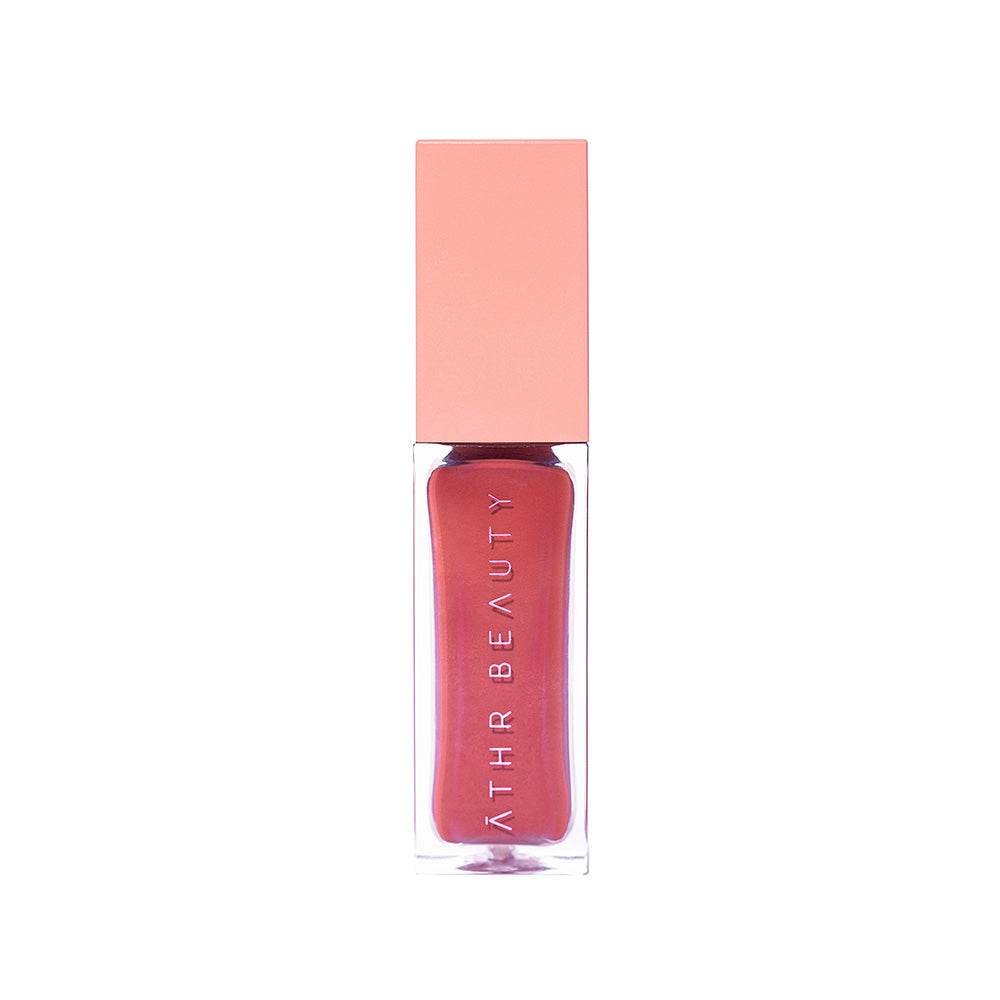 Pink lip gloss with a pink cap on a white background, branded as Ather Beauty.