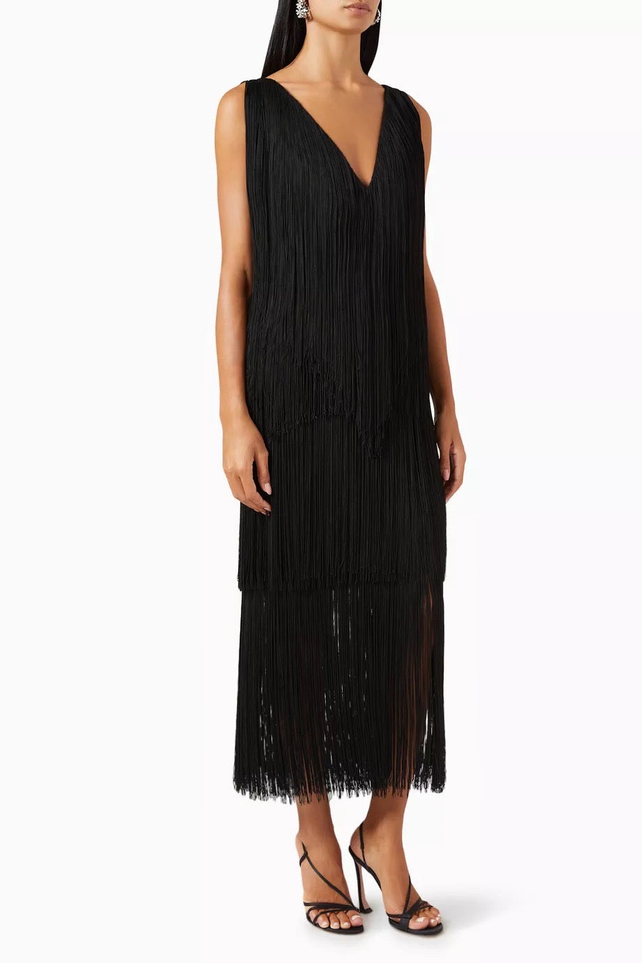 Black fringe dress worn by a model on a white background
