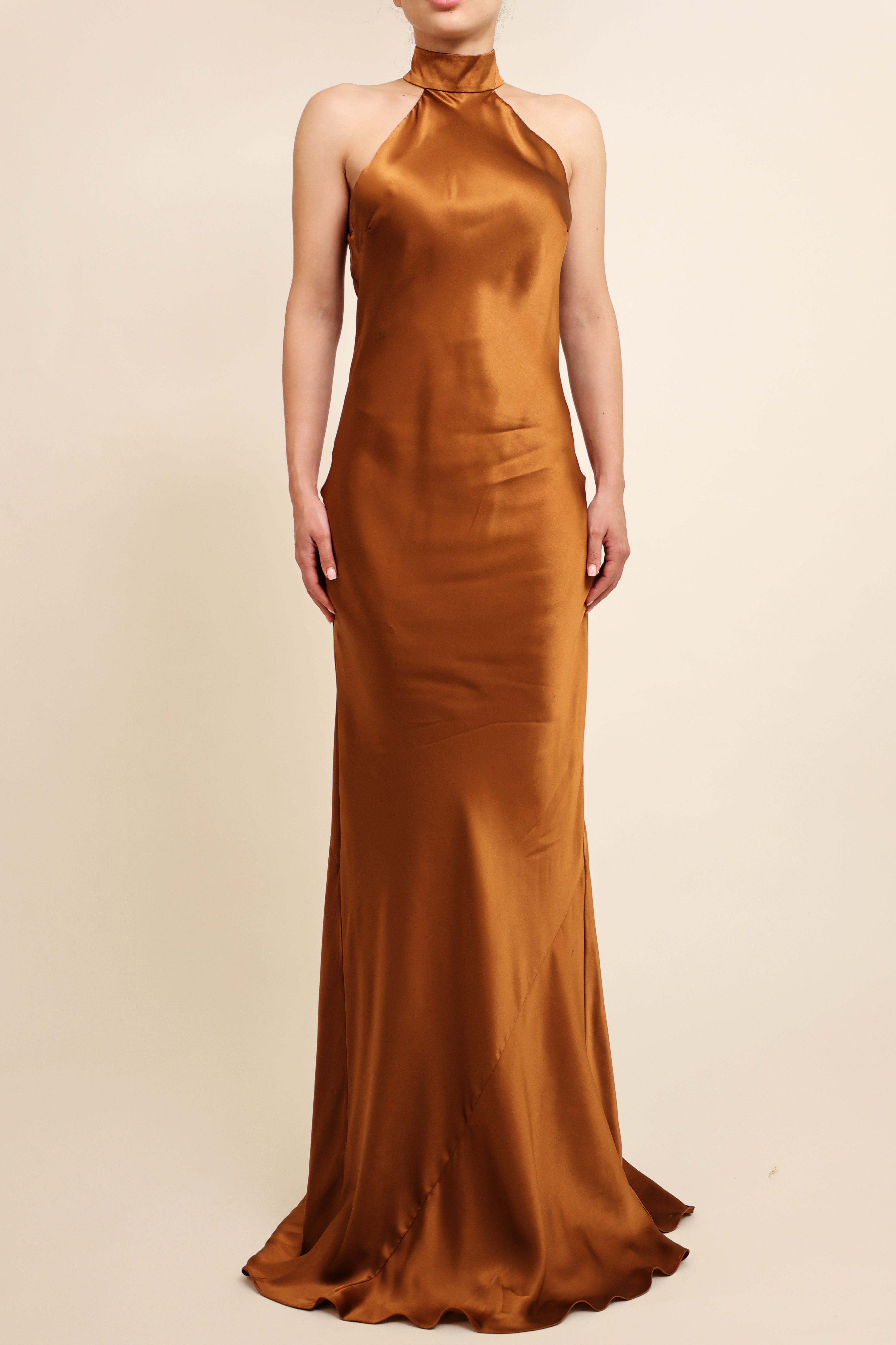 Gold evening gown on a beige background