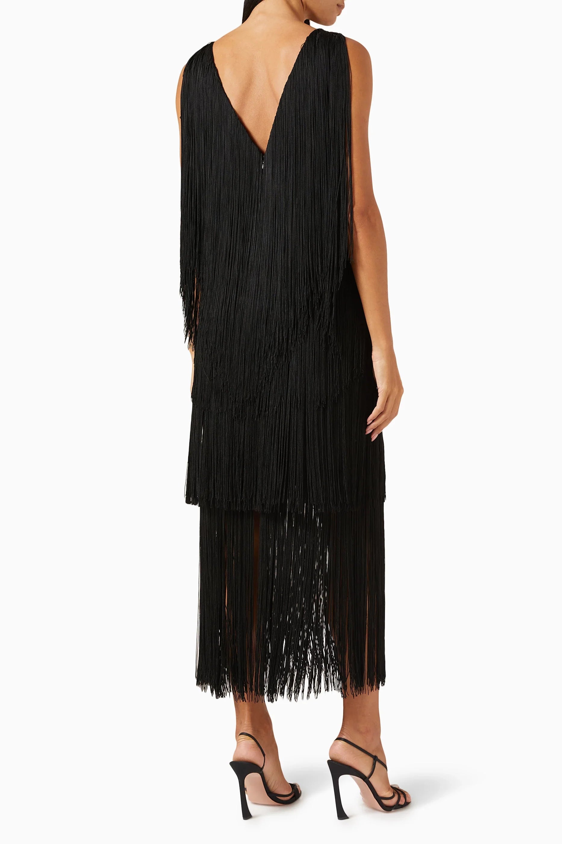 Black fringe dress worn by a person on a white background