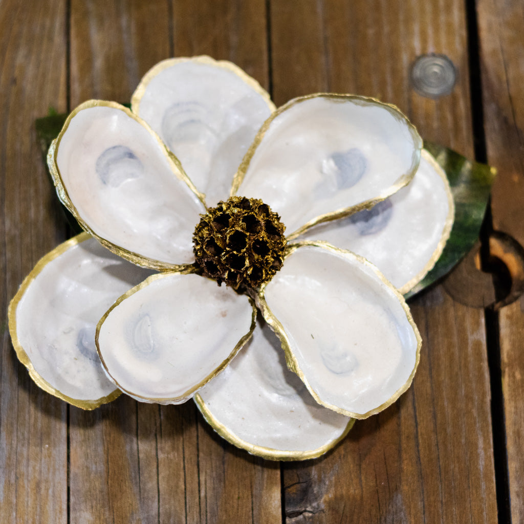 Decorative oyster shell flower on a wooden surface