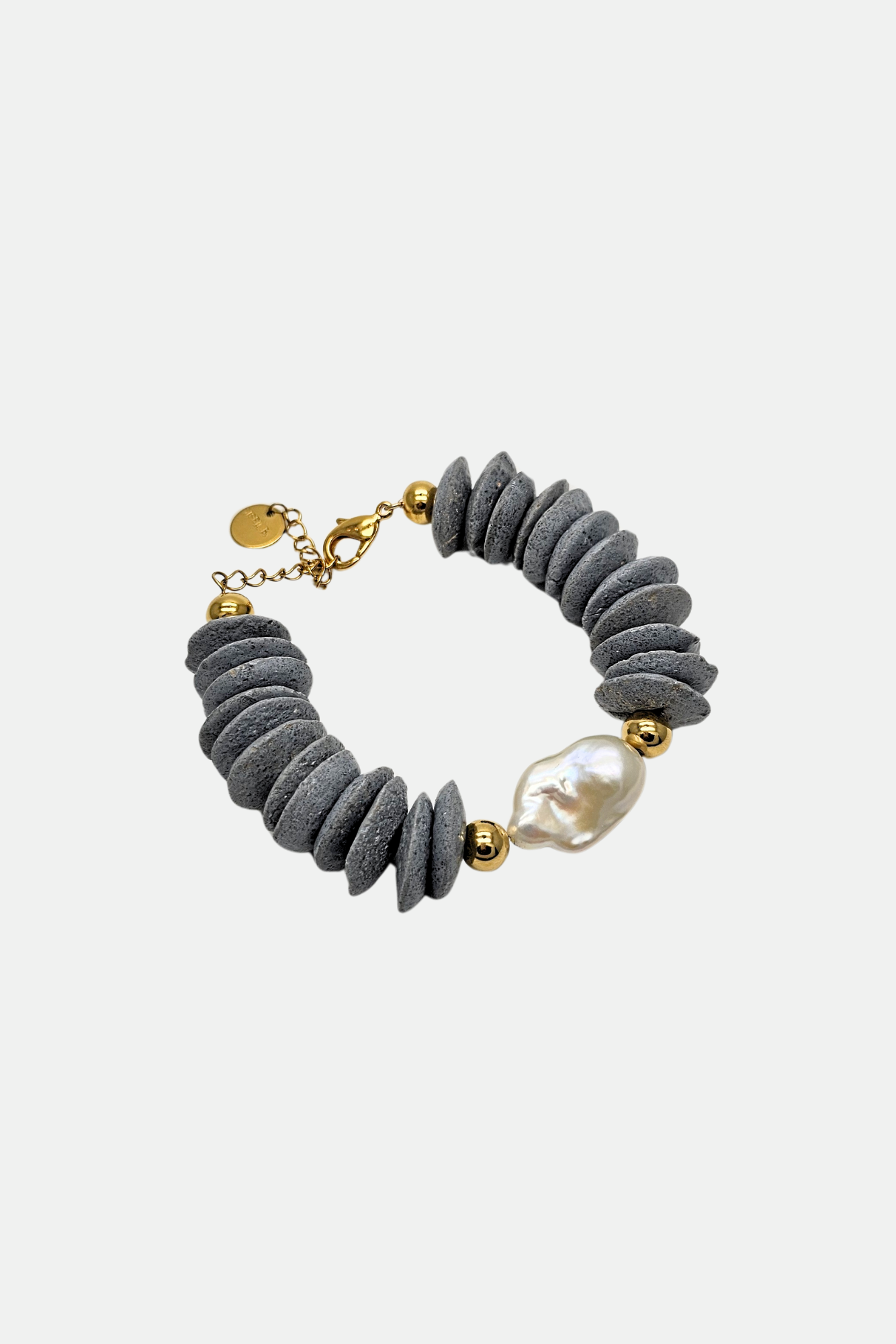 Gray bracelet with gold accents and a pearl on a white background