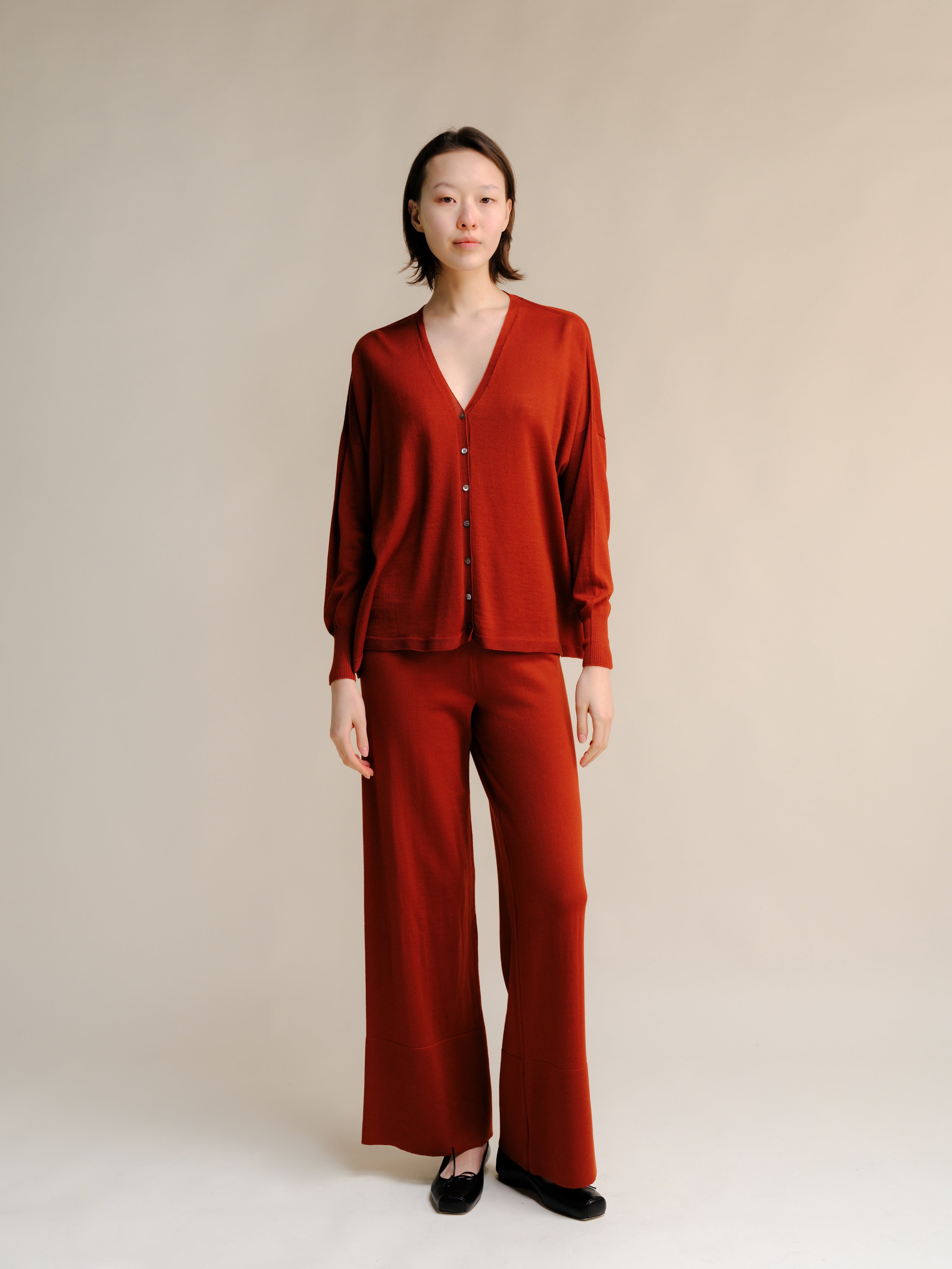 Woman wearing a red outfit against a plain background