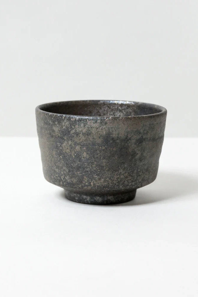 Dark gray ceramic cup on a white background