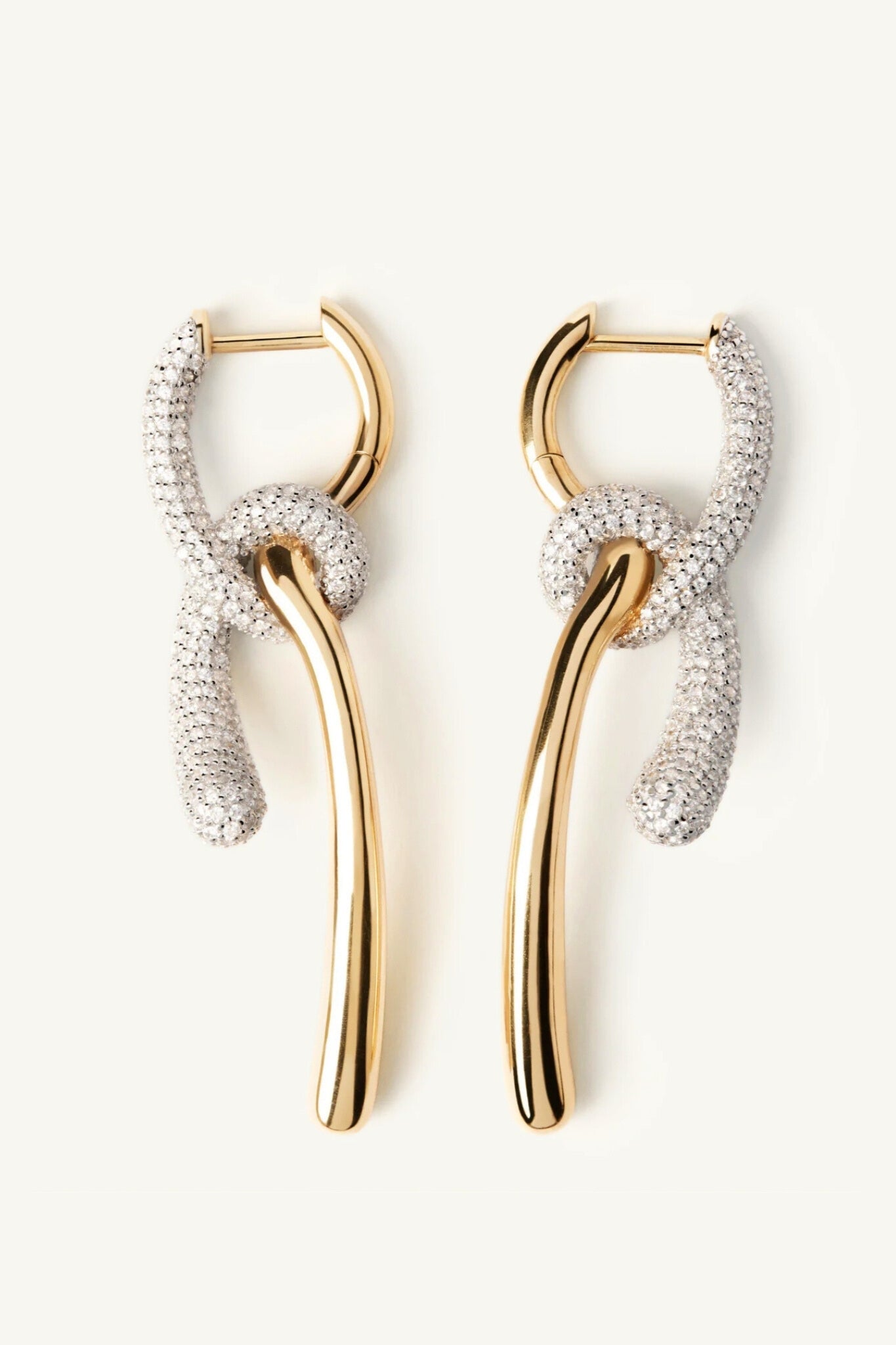 Pair of gold hoop earrings with diamond-studded loops on a white background