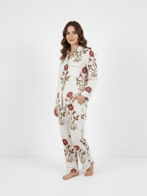 Woman wearing a floral pajama set on a white background
