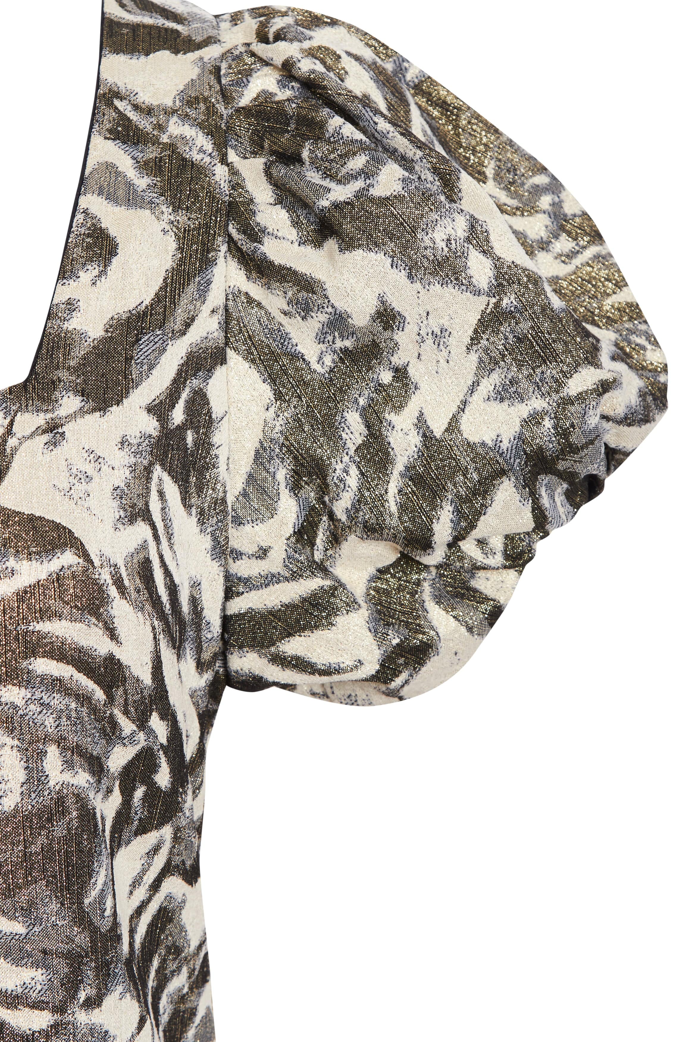 Patterned fabric with a mix of beige, brown, and black on a white background