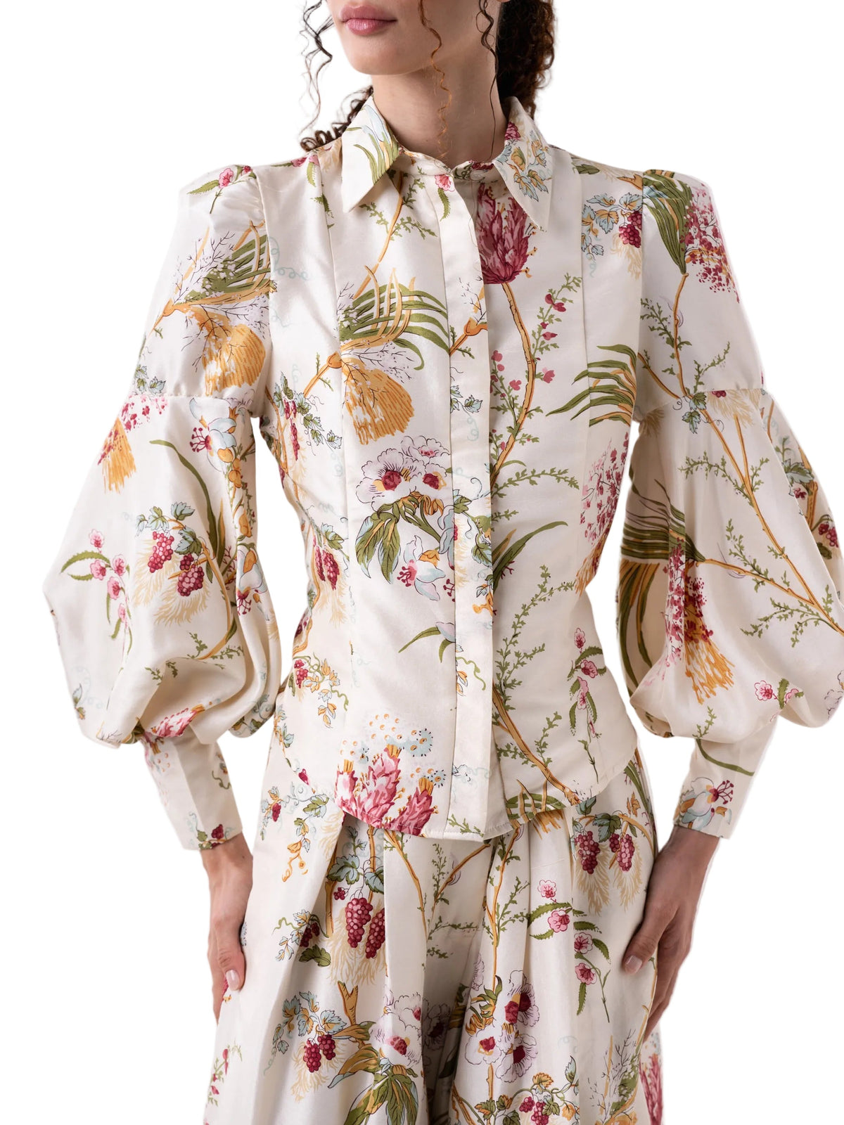 Floral patterned blouse with puff sleeves on a white background