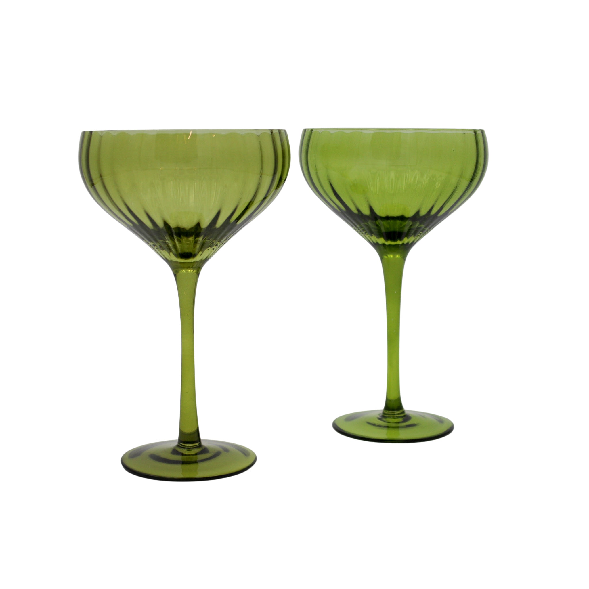 Two green glass goblets on a white background