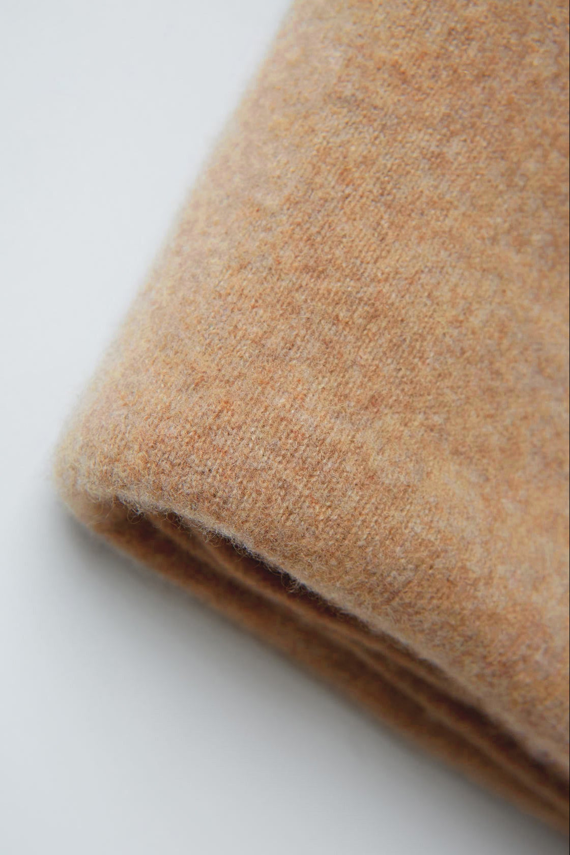 Close-up of beige fabric on a white background