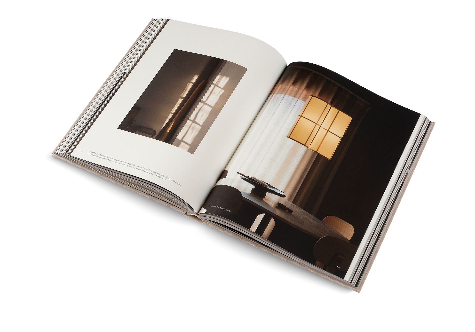 Open book showing interior design images of a room with a window.