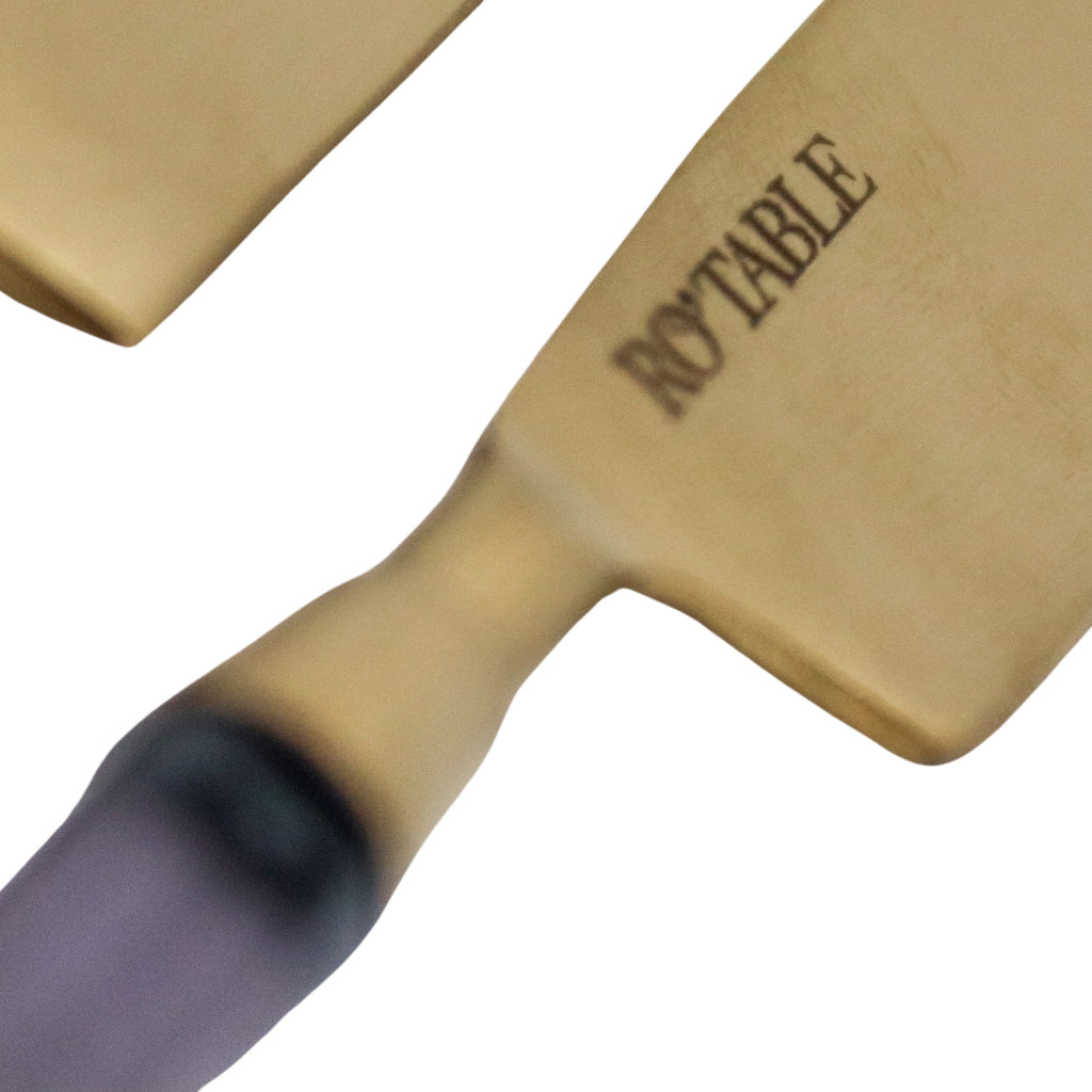 Close-up of a kitchen knife with a beige handle and 'ROYTABLE' branding on a white background.