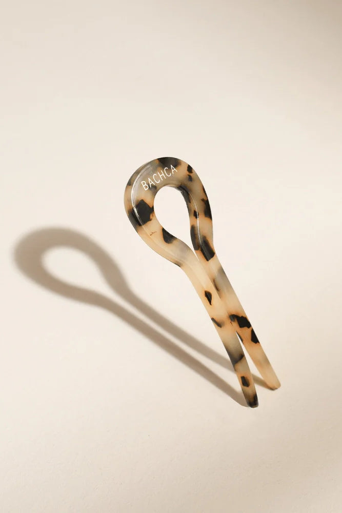 Tortoiseshell hair clip on a beige background