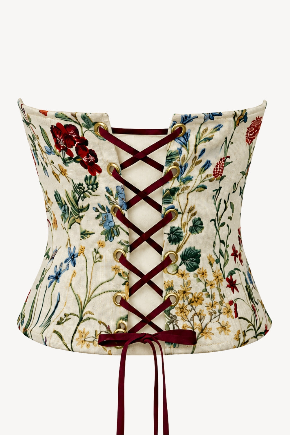 A vintage-style corset top with a cream-colored fabric covered in a detailed red, green, and yellow floral pattern, featuring dark red laces tied across the back.