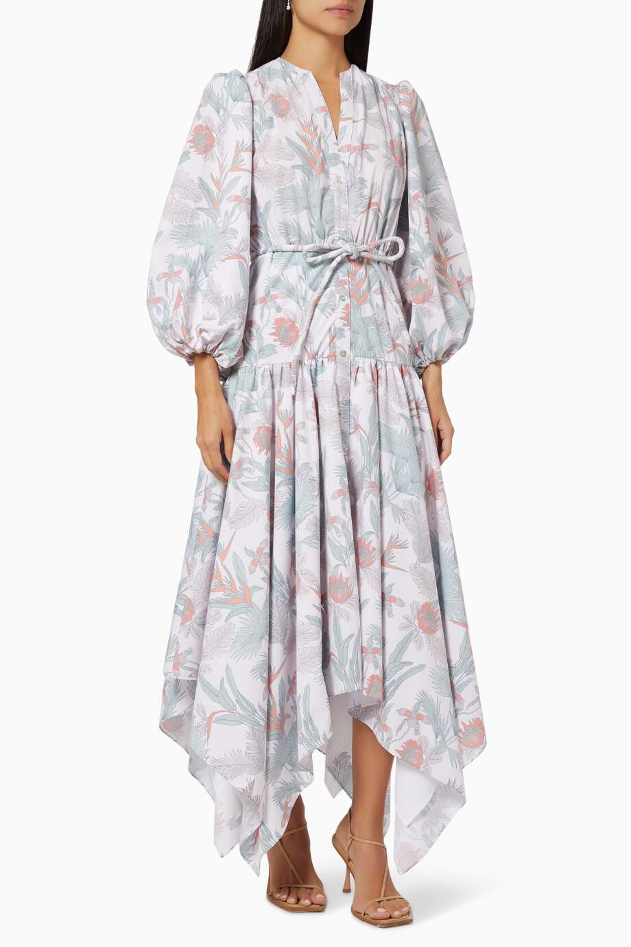 Woman wearing a floral dress with puffed sleeves on a white background