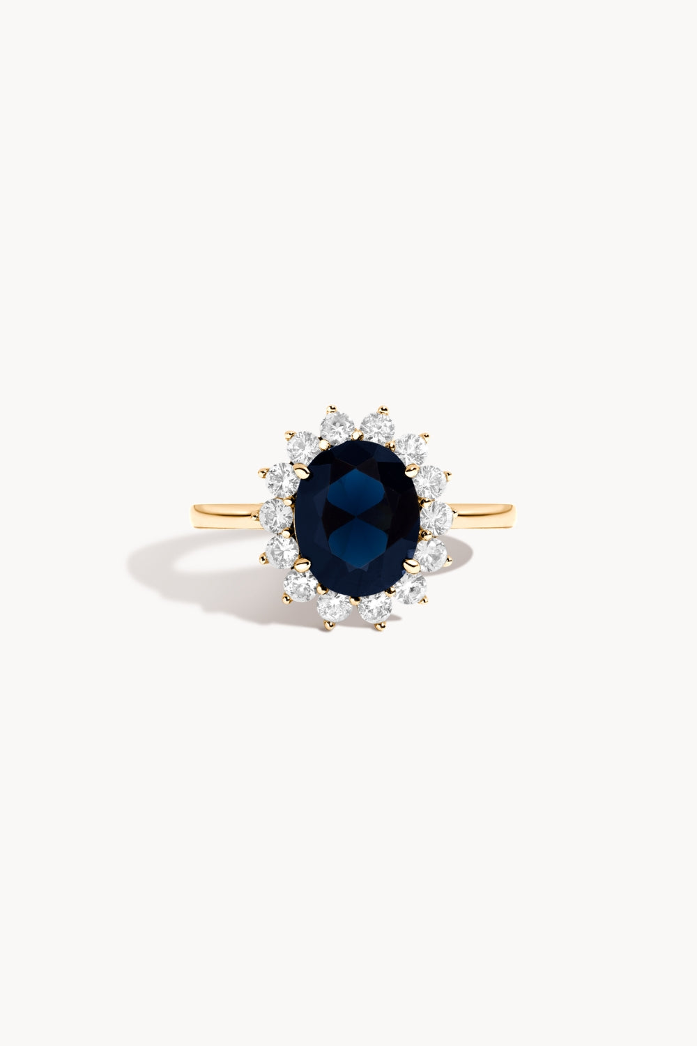 Royal blue sapphire ring with white sapphires and gold band.