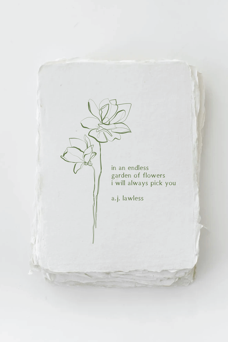 White ceramic dish with floral design and text on a light gray background