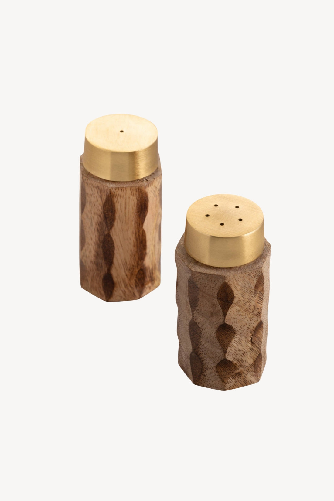 Two wooden salt and pepper shakers with gold lids on a white background