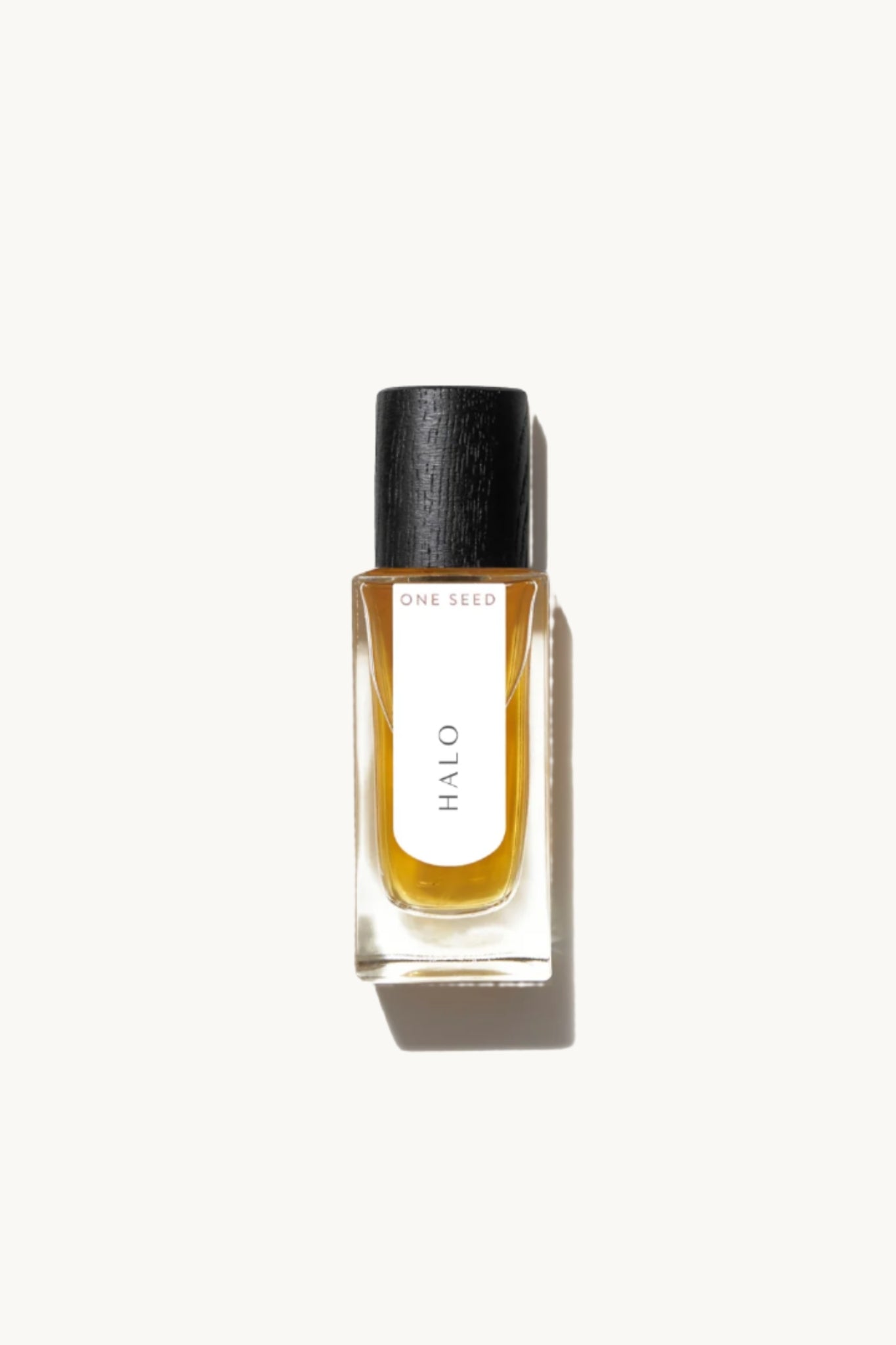 A clear glass bottle of One Seed Halo Eau De Parfum with a black cap, containing 30ml of the fragrance.