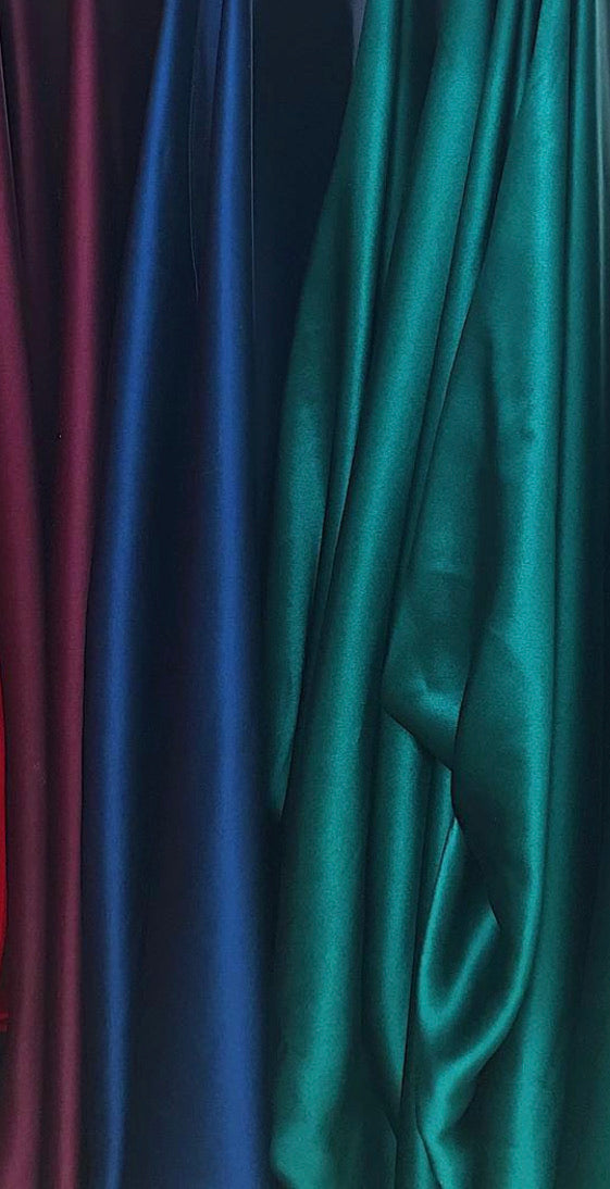 Close-up of draped fabric in red, blue, and green.