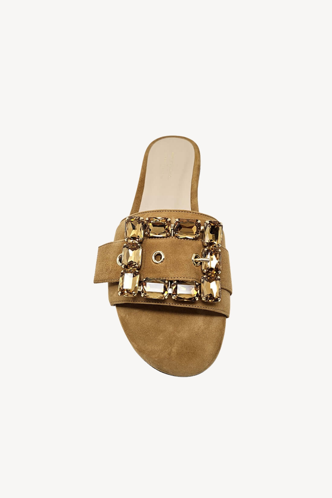 Tan sandal with decorative jewel buckle on a white background