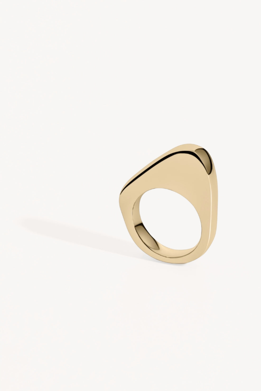 Gold asymmetrical  ring on a white background