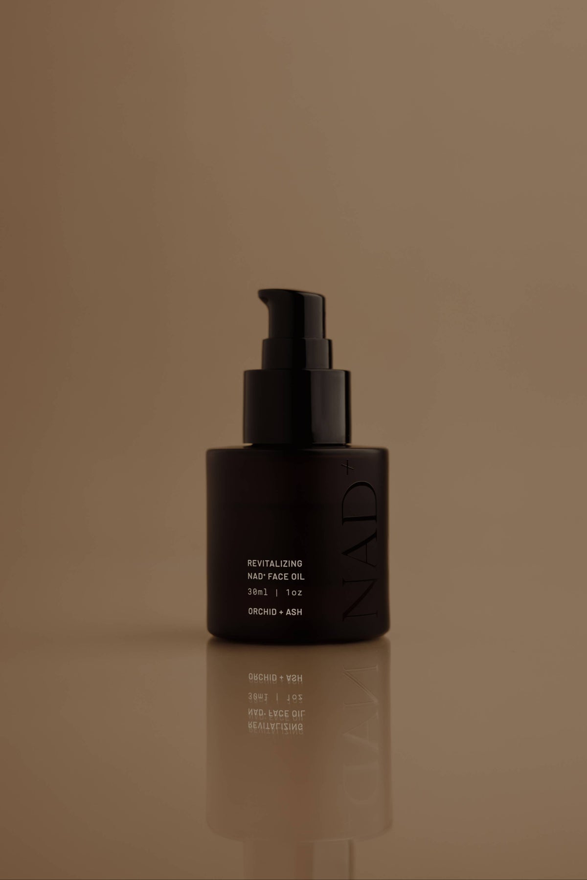 NAD+ skincare bottle with pump on a brown background