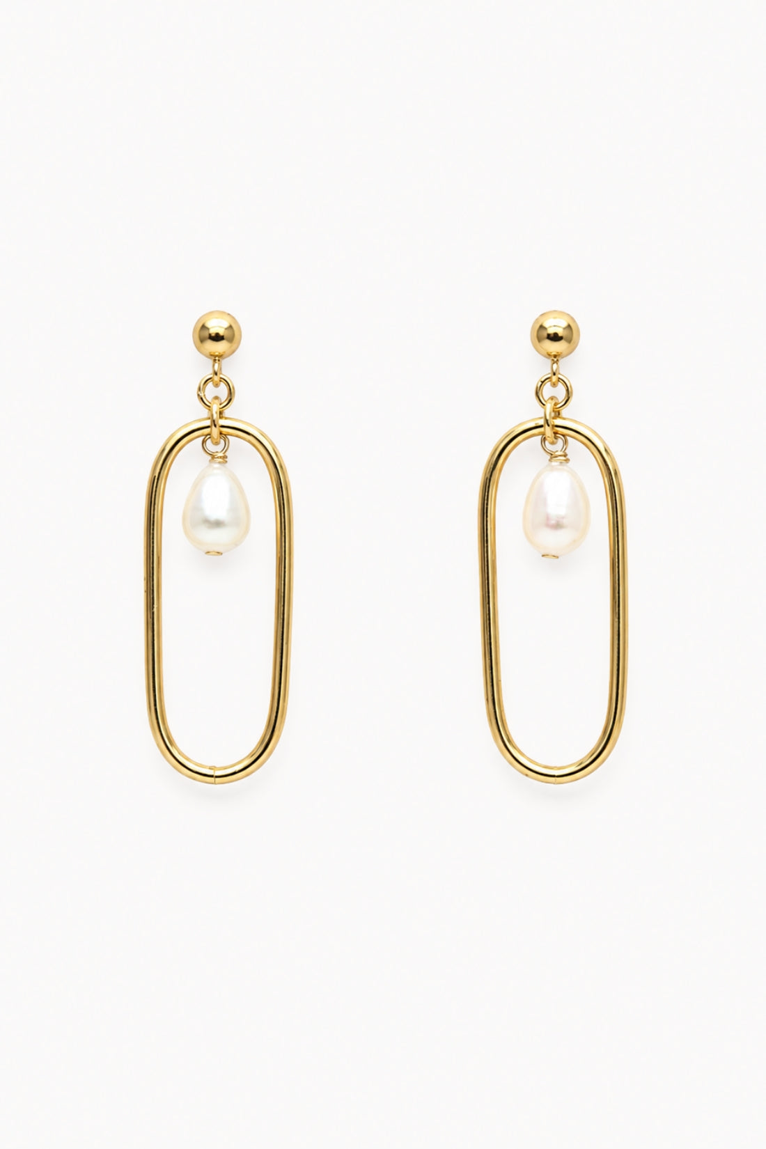 Gold oval earrings with pearl drops on a white background