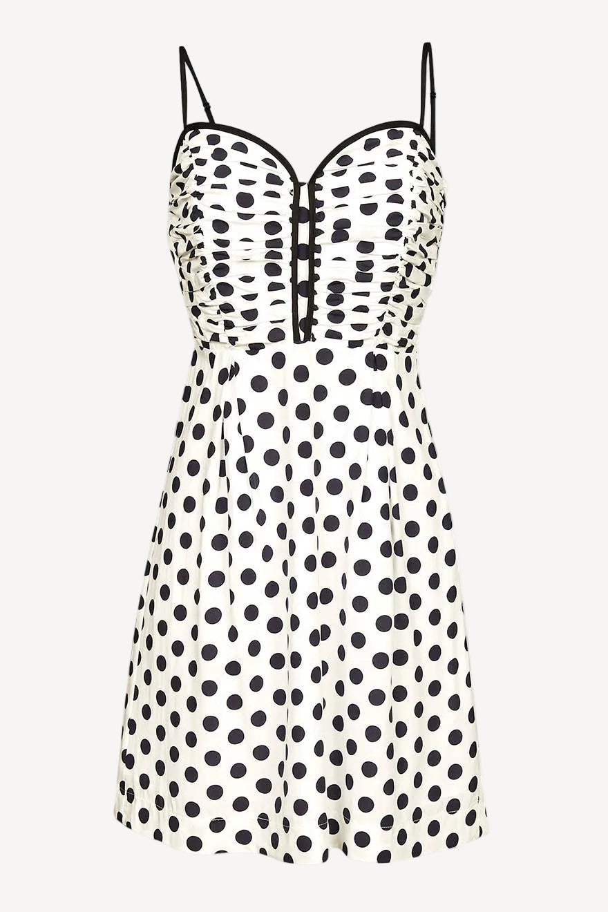 White polka dot mini dress floating in whitespace.